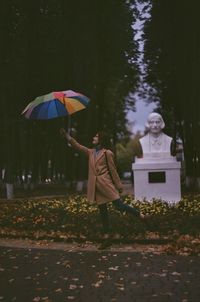 Man with umbrella standing on wet rainy day