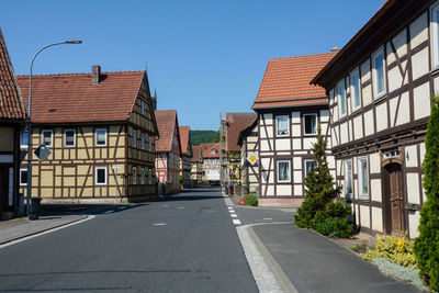 Road amidst buildings against sky in city