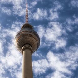 Low angle view of tower and building against sky