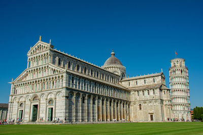 Low angle view of historical building against clear blue sky
