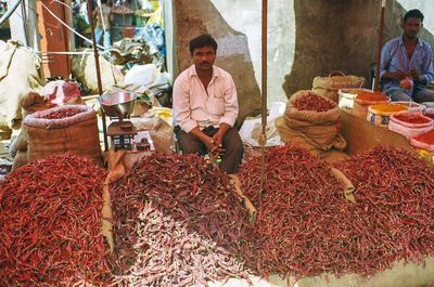 Man sitting at market stall