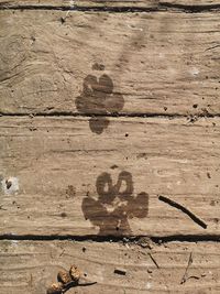 Close-up of heart shape on wood against wall