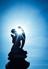 Low angle view of statue against blue sky