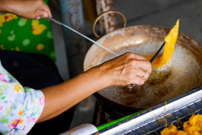 Midsection of man preparing food