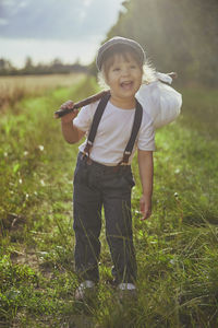 Adorable street child in a field at sunset