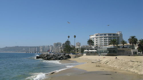 View of beach and buildings against sky