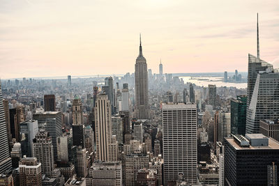 Aerial view of buildings in city against sky