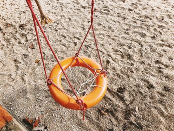High angle view of orange rope on sand