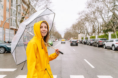 Portrait of young woman standing on street