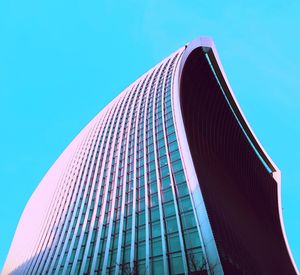 Low angle view of skyscrapers against clear blue sky