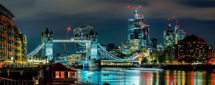 Illuminated buildings against sky at night