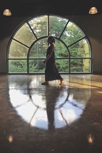 Woman standing by window