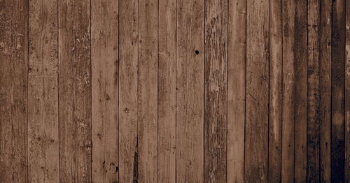Wooden natural background with light sepia art processing. fragment of old wooden wall cladding.