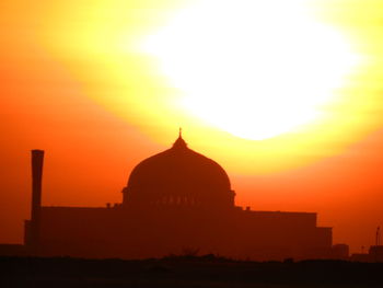 Silhouette temple against sky during sunset