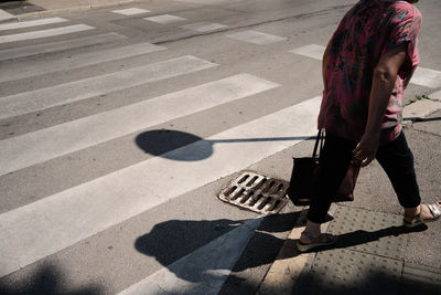 High angle view of woman walking on road