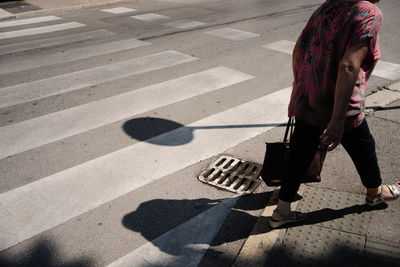 High angle view of man walking on road