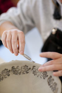 Woman making pottery bowl