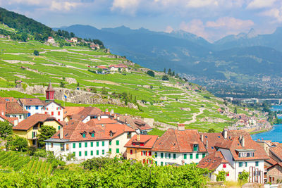 Scenic view of townscape and mountains against sky