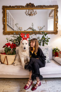 Portrait of dog sitting on sofa at home