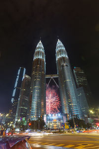 Illuminated modern buildings in city at night