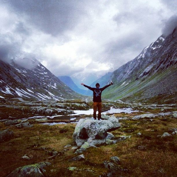 mountain, full length, leisure activity, lifestyles, sky, mountain range, standing, cloud - sky, tranquil scene, tranquility, scenics, casual clothing, beauty in nature, nature, landscape, cloud, rear view, arms outstretched