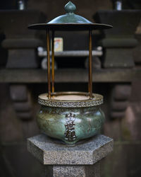 Close-up of antique containers on table