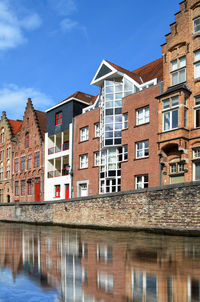 Low angle view of houses against blue sky