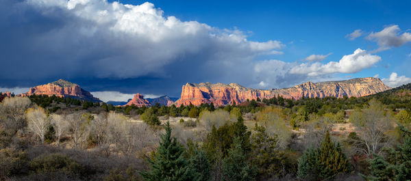 Panoramic view of rocks on mountain against cloudy sky