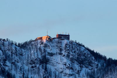 Snow covered buildings against sky