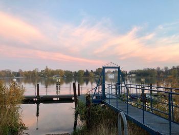 Bridge over river against sky during sunset