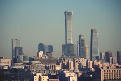 Modern buildings in city against clear sky