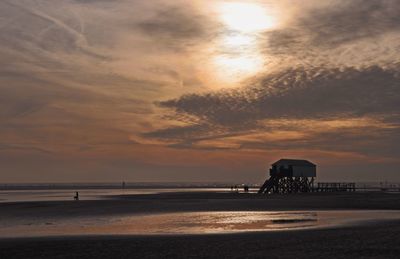 Scenic view of beach against sky during sunset