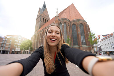 Self portrait of smiling woman in hanover main square, germany