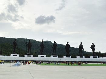 Group of people in front of building against sky