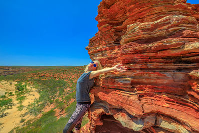 Woman standing by rock formation at kalbarri national park 