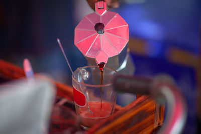 Close-up of red wine glass on table