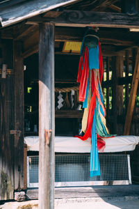 Fabrics hanging on wood at shrine