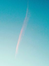 Low angle view of vapor trail against blue sky