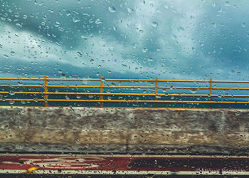 Raindrops on glass window of rainy season