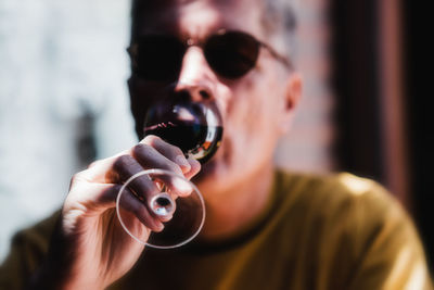 Close-up of man drinking wine