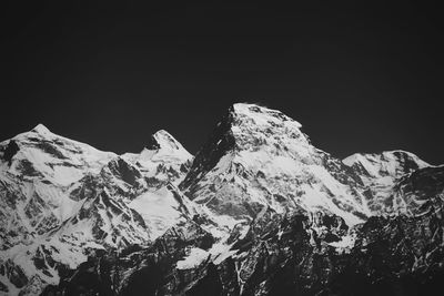 Scenic view of snowcapped mountains against sky at night