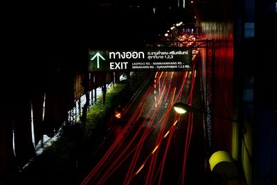 Illuminated sign on street in city at night