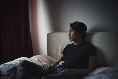 Pensive man sitting on sofa