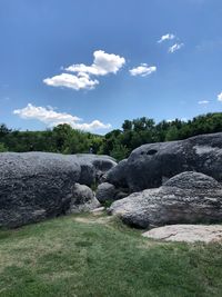 Rocks on field against sky