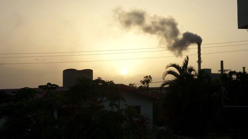 View of built structures against sunset