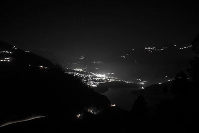 Illuminated trees against sky at night