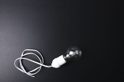 High angle view of light bulb against black background