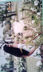 Portrait of woman holding plant