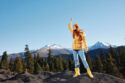 Rear view of woman standing on mountain