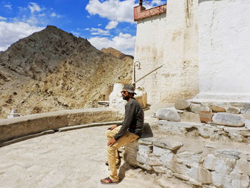 Full length of man standing against wall